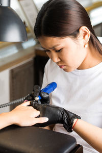 Side view of young woman using mobile phone at home