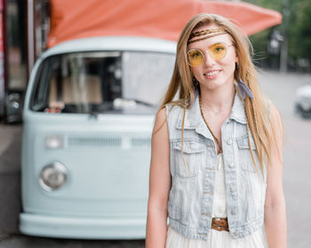 Portrait of smiling young woman standing outdoors