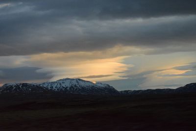 Scenic view of snowcapped mountains against sky during sunset