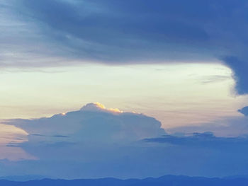 Scenic view of majestic mountains against sky during sunset