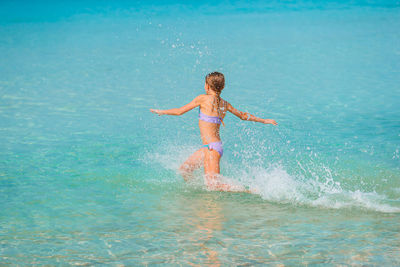 Full length of shirtless boy in sea