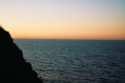 Scenic view of sea against clear sky during sunset