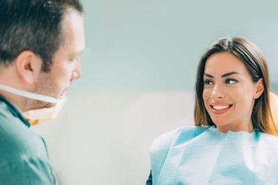 Smiling patient looking at dentist