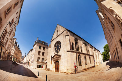 Low angle view of buildings against blue sky