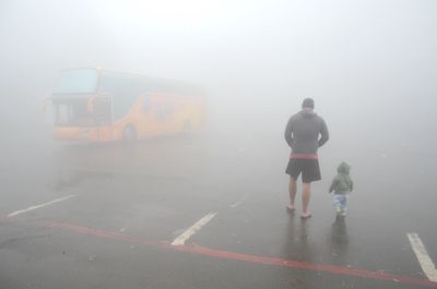 Woman standing in foggy weather