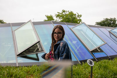 Portrait of woman standing against sky