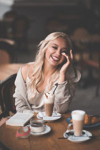 Young woman sitting on table