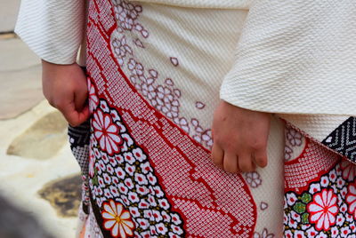Midsection of woman wearing traditional clothing