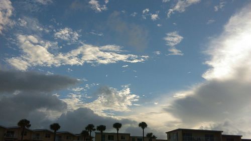 Low angle view of building against cloudy sky