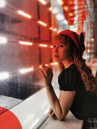 Portrait of a girl looking away while sitting on floor