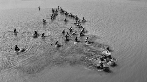 High angle view of people with earthenware in sea