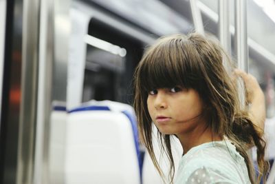 Portrait of girl with brown hair in train