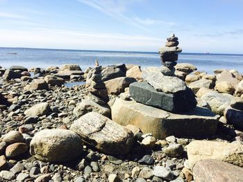 Close-up of rocks on beach against sky