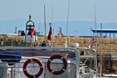 Flags on boat against sky