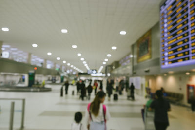 People walking in illuminated lights