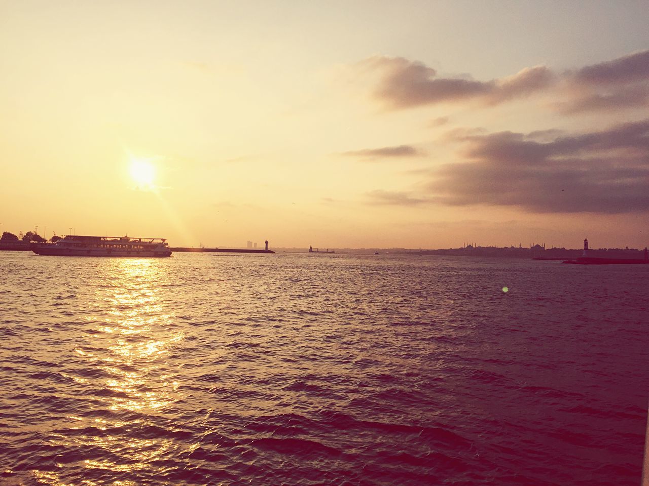 water, sunset, tranquil scene, scenics, sea, waterfront, sun, tranquility, rippled, beauty in nature, sky, idyllic, reflection, nature, seascape, cloud, calm, distant, atmospheric mood, majestic, non-urban scene, cloud - sky, ocean, outdoors, remote, moody sky, atmosphere, no people