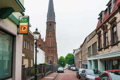 Street amidst buildings against sky in city