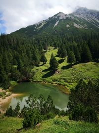 Scenic view of lake and mountains against sky