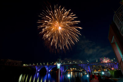 Low angle view of golden firework exploding display at night