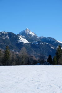 Scenic view of snowcapped mountains against clear sky