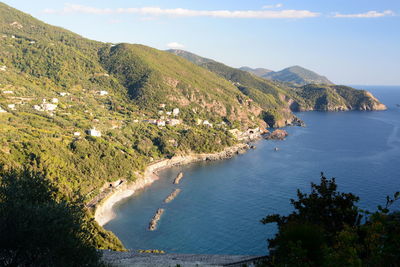 High angle view of sea and mountains against sky