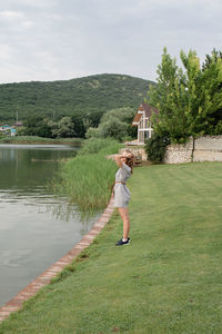 Nature and travel concept. woman standing near the lake
