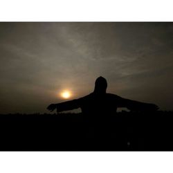 Silhouette man standing against sky during sunset