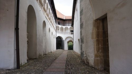 Alley amidst old buildings in city