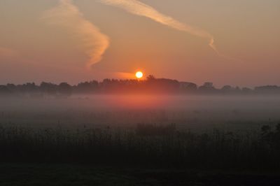 Scenic view of field against sky during sunset