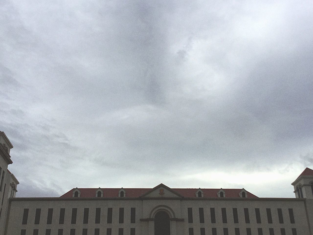 architecture, built structure, sky, low angle view, building exterior, cloud - sky, cloudy, overcast, weather, cloud, high section, building, outdoors, storm cloud, day, no people, window, cloudscape, city, nature