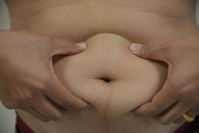 Midsection of man with hand on stomach