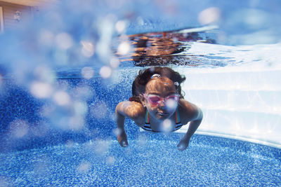 Portrait of young woman swimming in pool