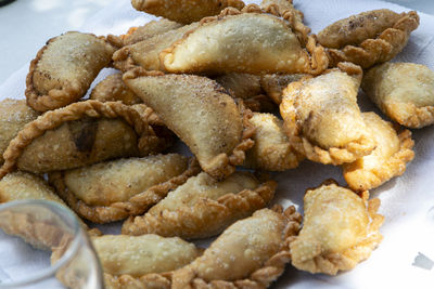 High angle view of argentine fried empanadas in plate on table