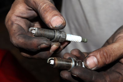 Cropped hand of man repairing electronic cigarette