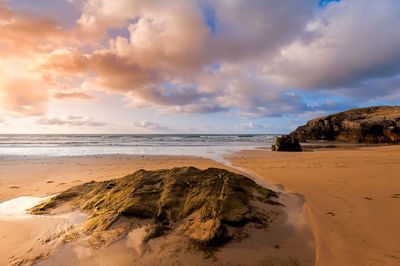 Scenic view of beach against sky during sunset