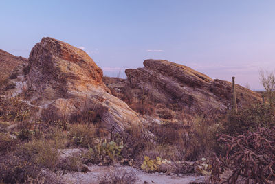 Rock formations on landscape against clear sky