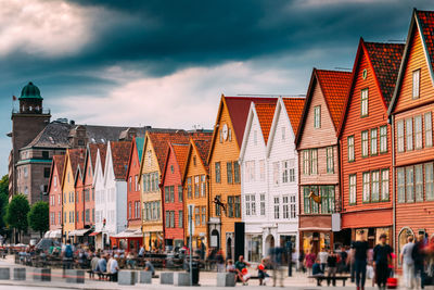 Blurred motion of people walking on street by houses in town