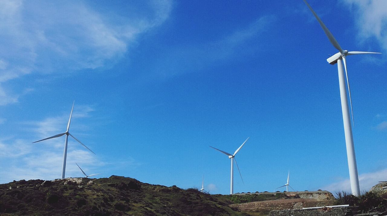 wind turbine, alternative energy, wind power, windmill, renewable energy, environmental conservation, fuel and power generation, technology, low angle view, traditional windmill, sky, landscape, blue, sustainable resources, field, rural scene, day, electricity, no people, outdoors