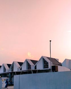 Low angle view of houses against sky during sunset