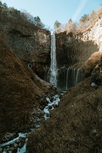 Scenic view of waterfall against sky