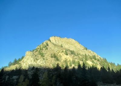 Low angle view of mountain against clear blue sky