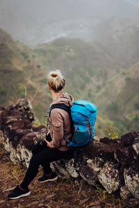 Woman of sitting on rock