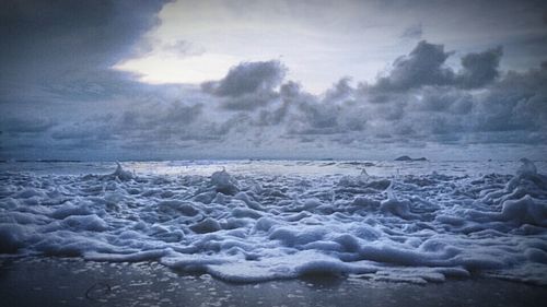Scenic view of sea against cloudy sky