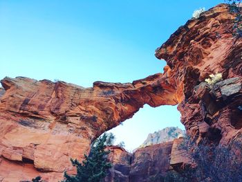 Low angle view of rock formations against sky