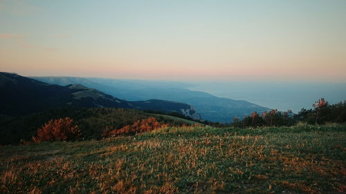 Scenic view of landscape against clear sky during sunset