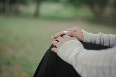 Close-up of woman hand on finger against blurred background