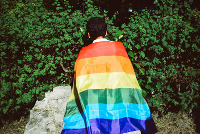 Rear view of man standing against trees