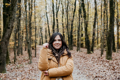 Portrait of a beautiful young woman, autumn, forest, outdoors.