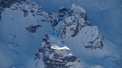 Aerial view of snowcapped mountains against sky