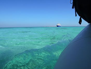 Cropped image of boat in sea against clear sky